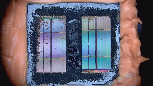 03 · Dies becoming exposed — Two dies are visible, with localized surface residue remaining.