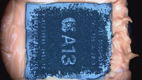 01 · Before decapsulation — The intact package surface retains the A13 marking.