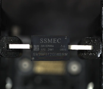 01 · Before decapsulation — The package exterior and device markings remain visible.