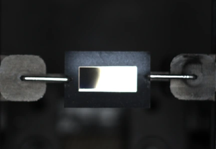 02 · Decapsulation complete — The central opening exposes the target die region.
